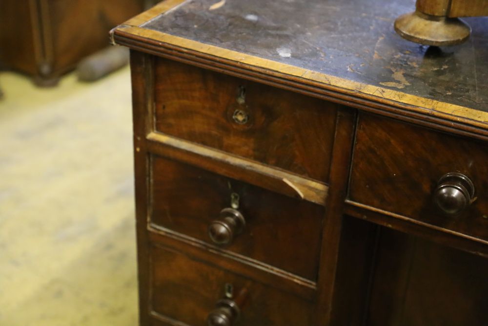 A George IV mahogany kneehole desk, with recessed cupboard, W.115cm, D.60cm, H.76cm